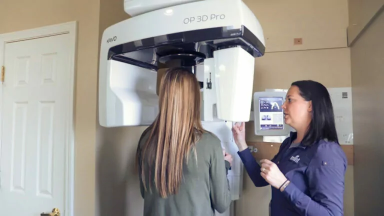 assistant running x-ray machine