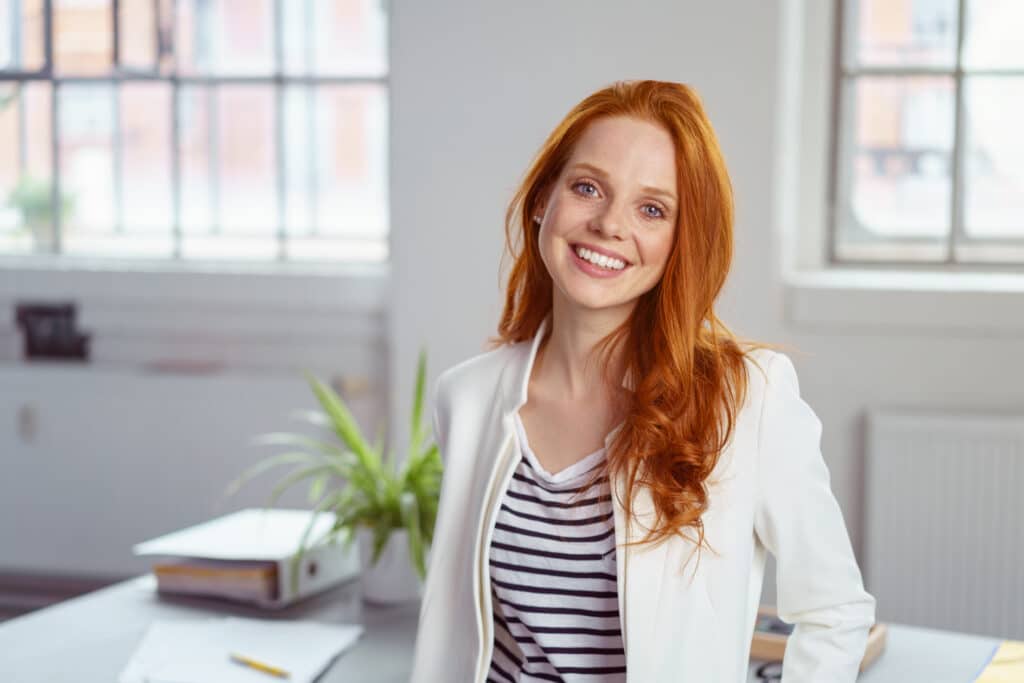 Stylish,Attractive,Young,Redhead,Businesswoman,With,A,Lovely,Smile,Standing
