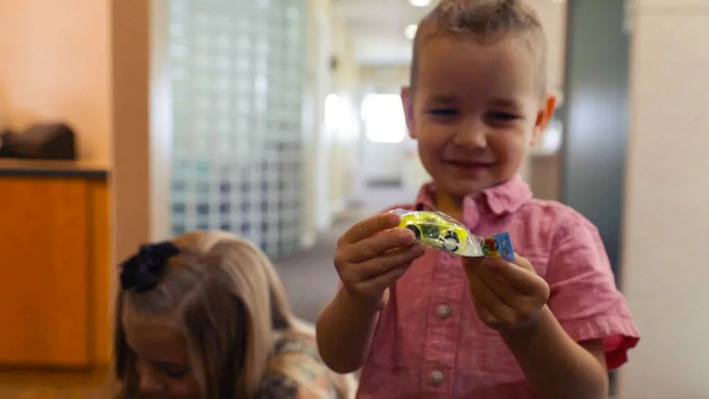child holding toy car from dentist